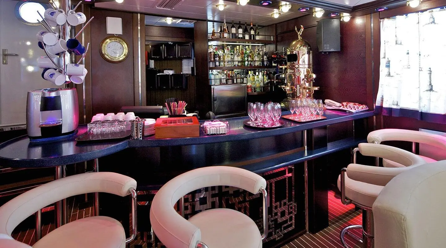 Luxurious yacht interior at sunset with chandeliers and plush seating