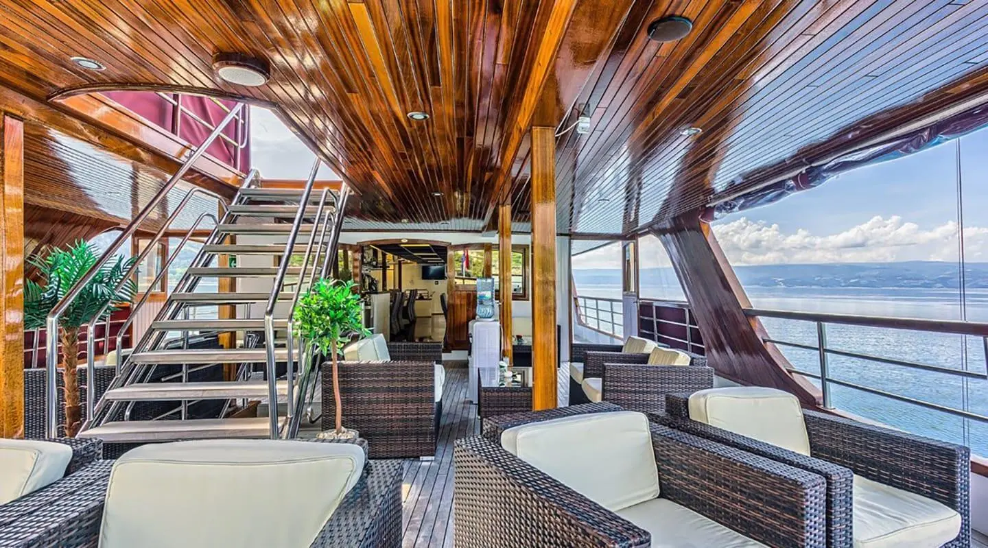 Melody yacht deck lounge at sunset with wooden beams and seating area