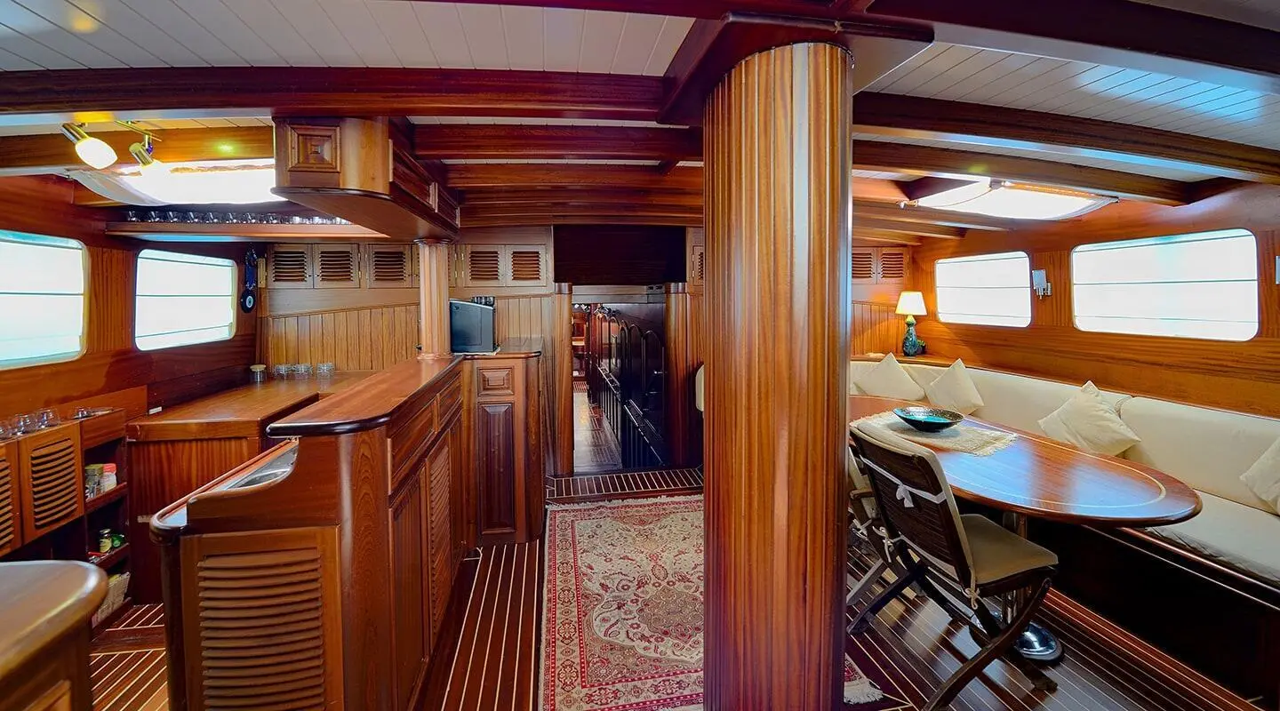 Inside Zephyria II luxury yacht saloon with polished wood, seating, and warm lighting