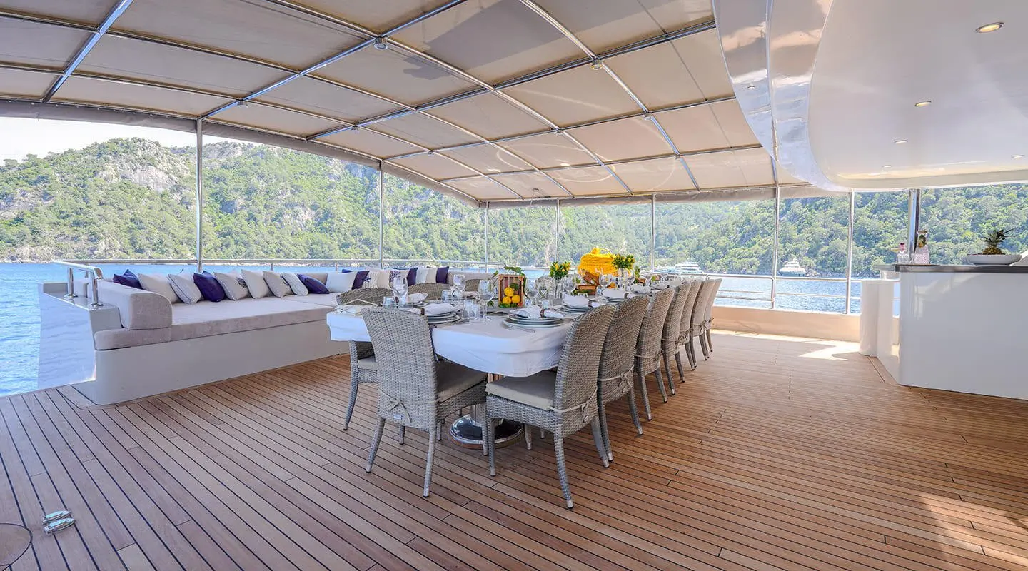 Aft deck of the King Of The Sea motor yacht with table and chairs