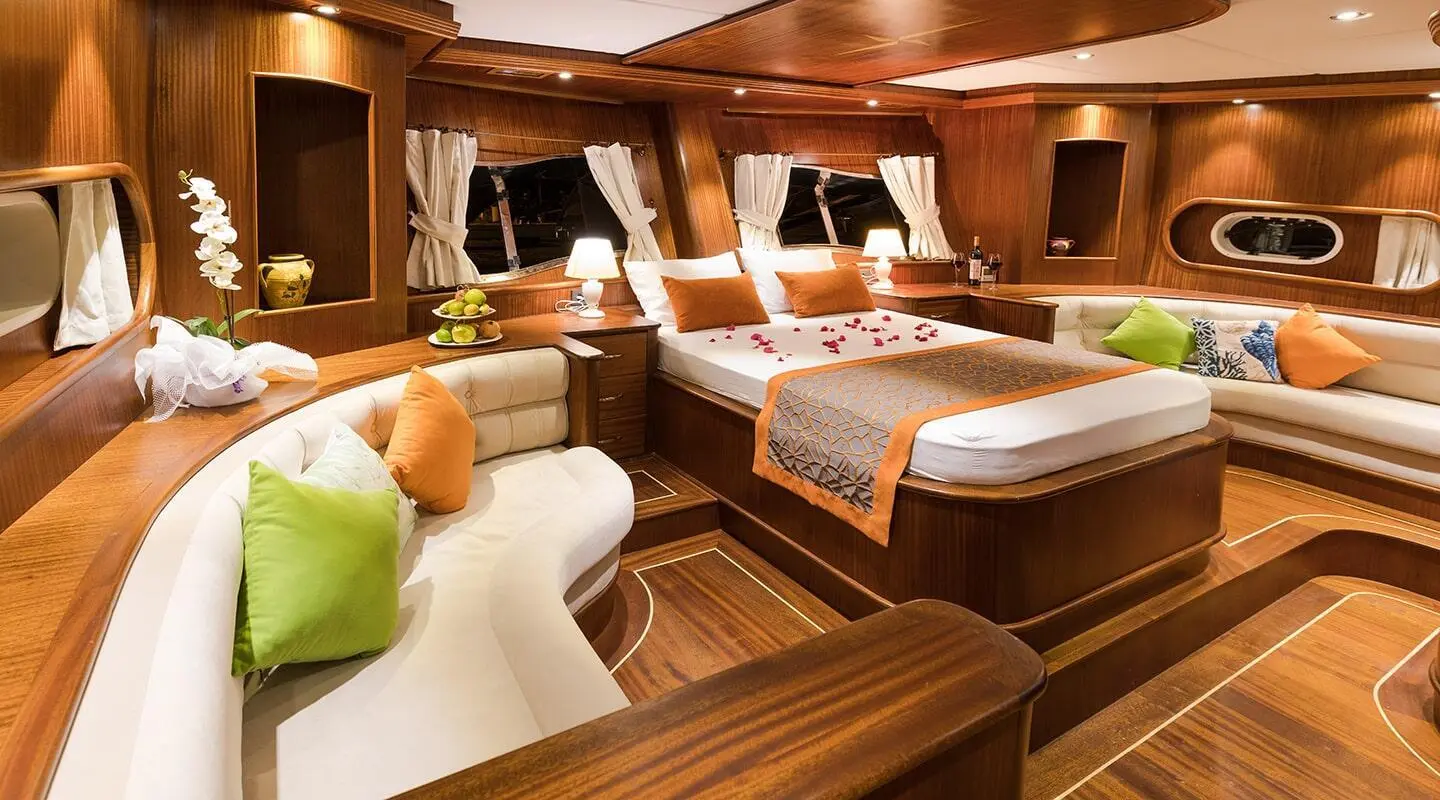 Inside deck area of Vista Mare luxury gulet with wooden furnishings and sun loungers