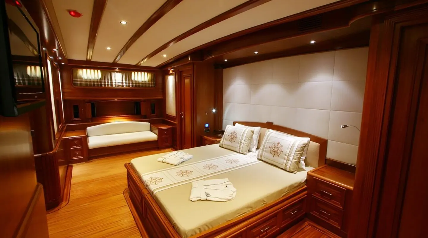 Kaya Guneri 5 luxury yacht interior cabin with wood paneling and king-size bed
