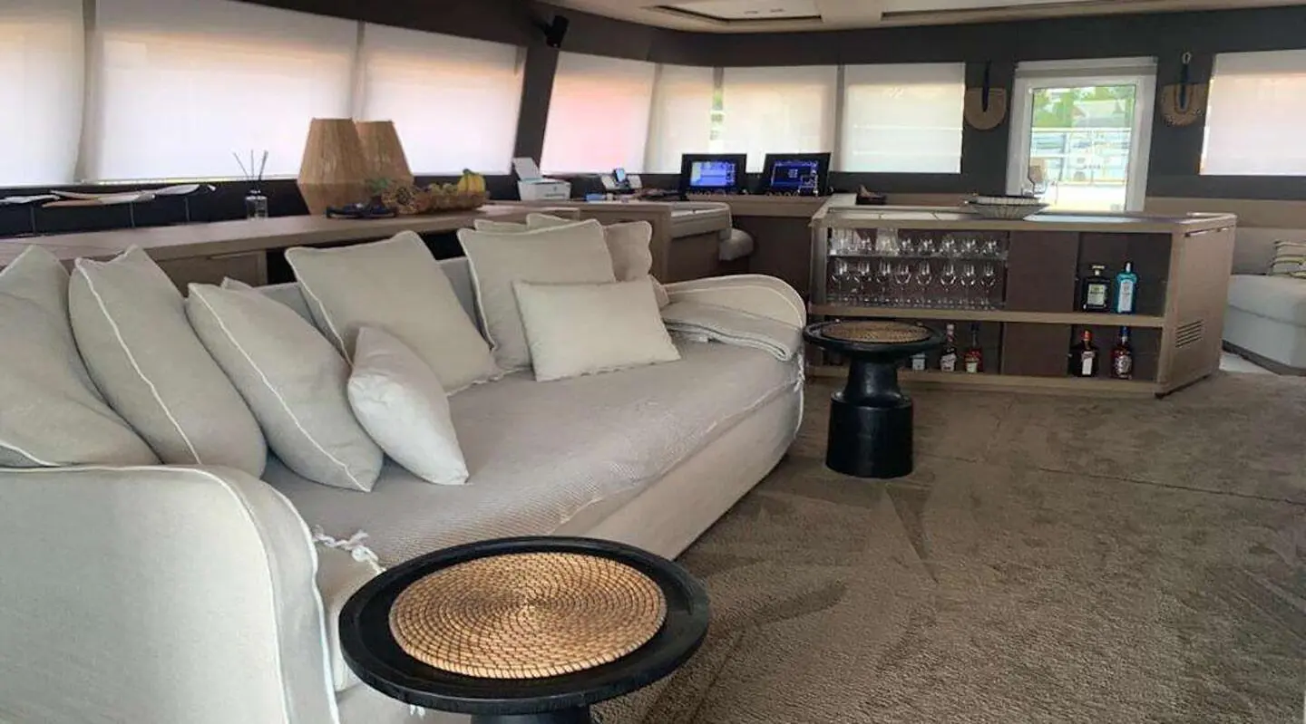 Just Marie 2 yacht saloon deck with large gray sofa and round coffee table
