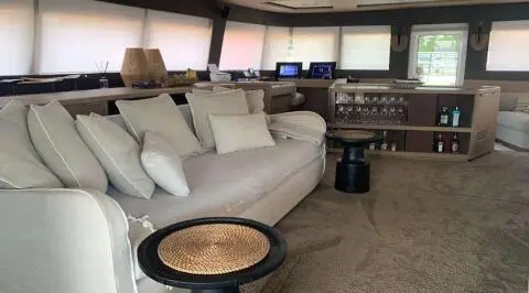 Just Marie 2 yacht saloon deck with large gray sofa and round coffee table