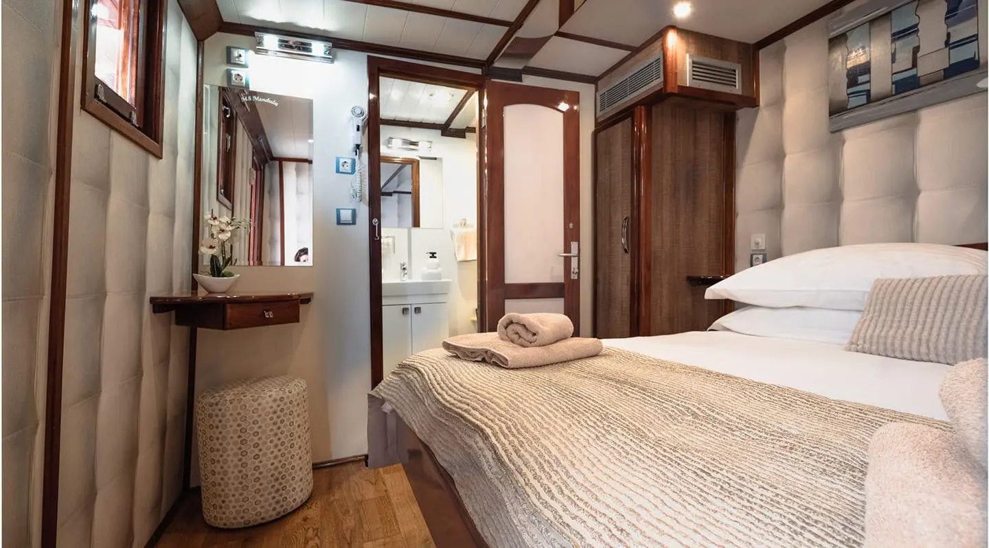 Mendula luxury yacht cabin interior with plush bed and wood accents