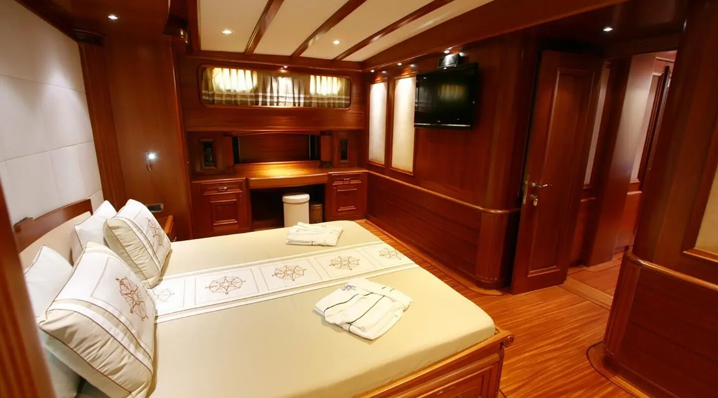 Kaya Guneri 5 yacht interior with wooden cabinetry and dining area at sunset