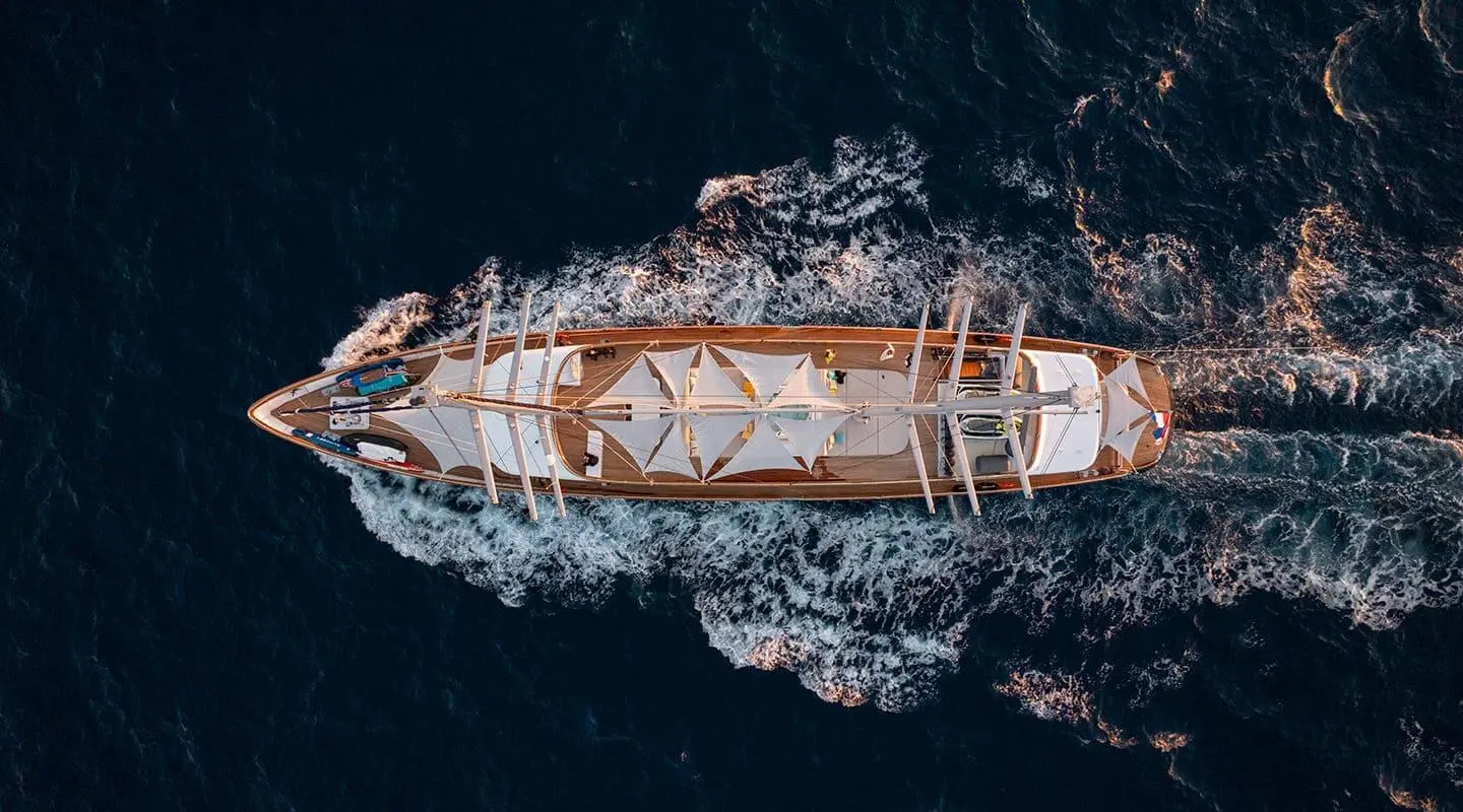 Aerial view of a luxury yacht Dalmatino anchored along rocky coastline