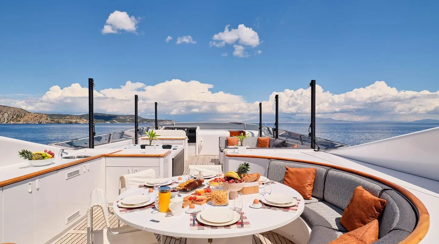 Mobius yacht dining deck with round table set for meals, ocean view