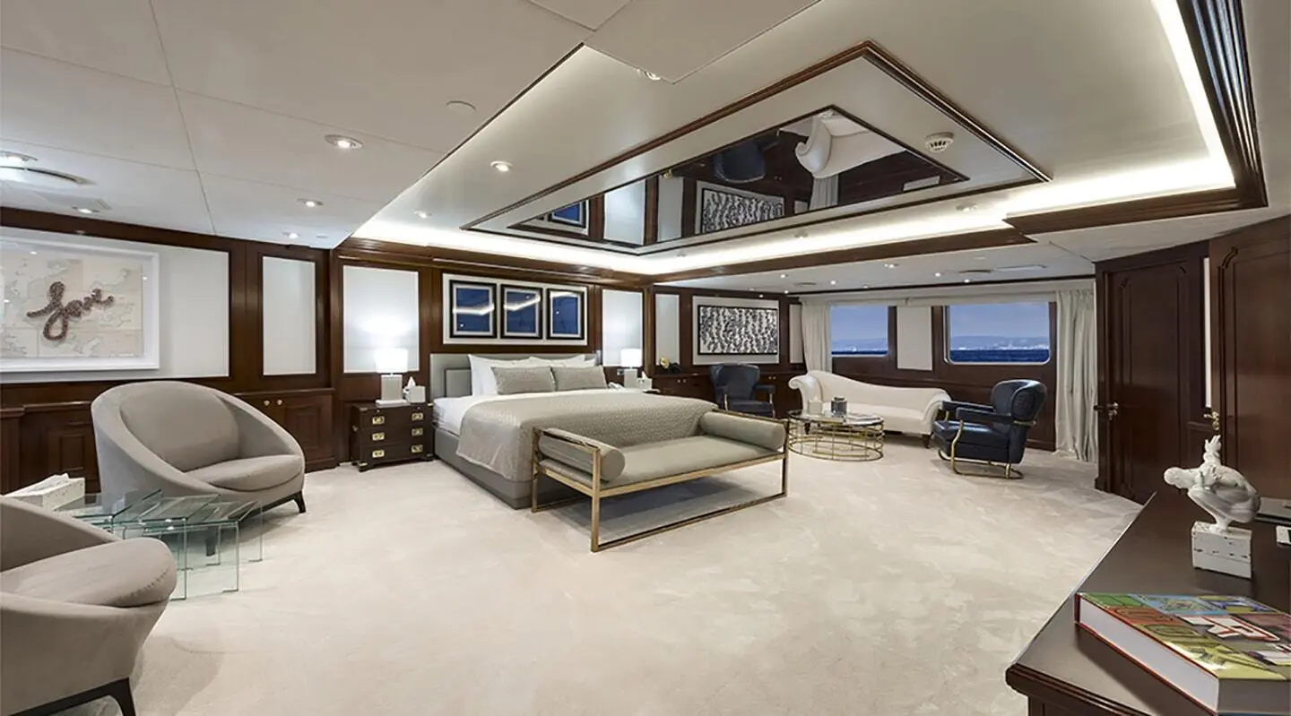 Interior of Chakra yacht lounge with sofas, coffee table, and large windows