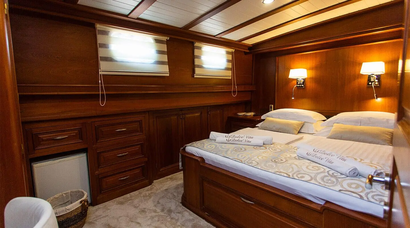 Dolce Vita gulet interior showing wooden cabinetry and double bed
