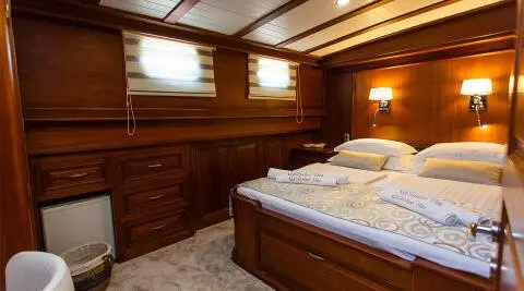 Dolce Vita gulet interior showing wooden cabinetry and double bed