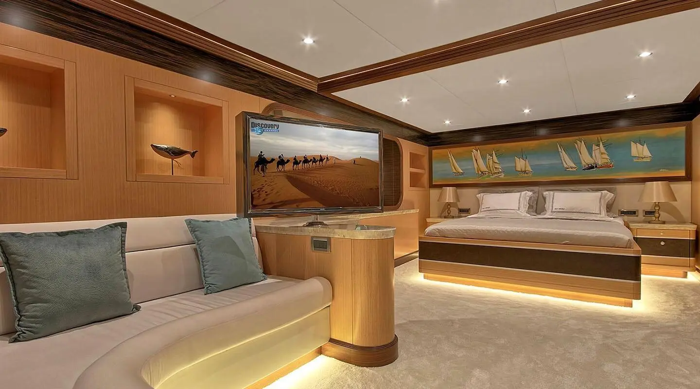 Meira yacht deck interior with seating, wooden accents, and large window view