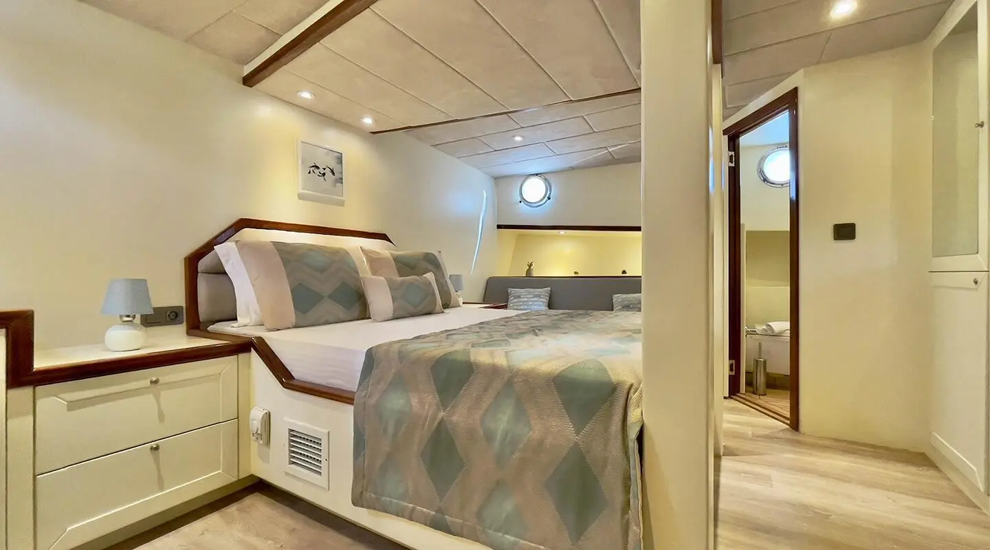 Derya Deniz luxury yacht cabin with bed, soft lighting and sea-toned decor