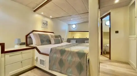 Derya Deniz luxury yacht cabin with bed, soft lighting and sea-toned decor