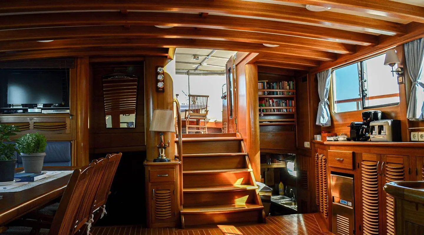 Enderim A luxury gulet interior with wooden stairs, warm lighting, and seating
