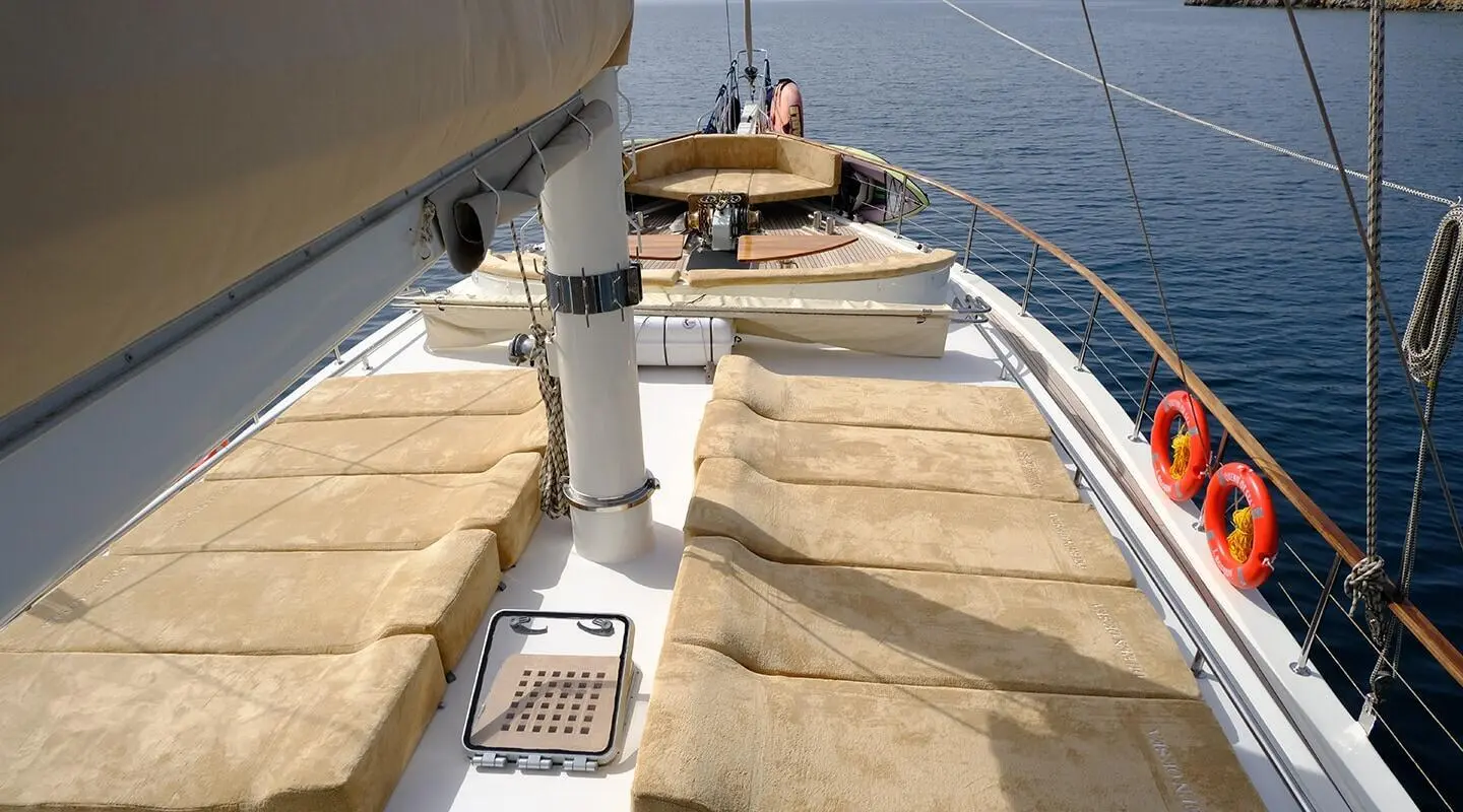 Sunset view from the Queen Of Sea yacht deck with seating and calm water