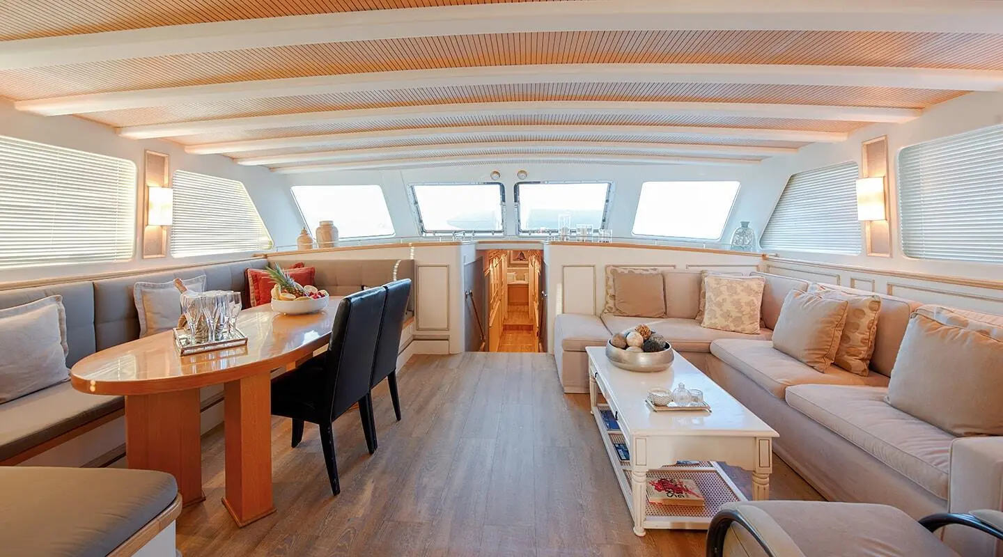 Interior of Cobra King yacht with dining table and sofa seating