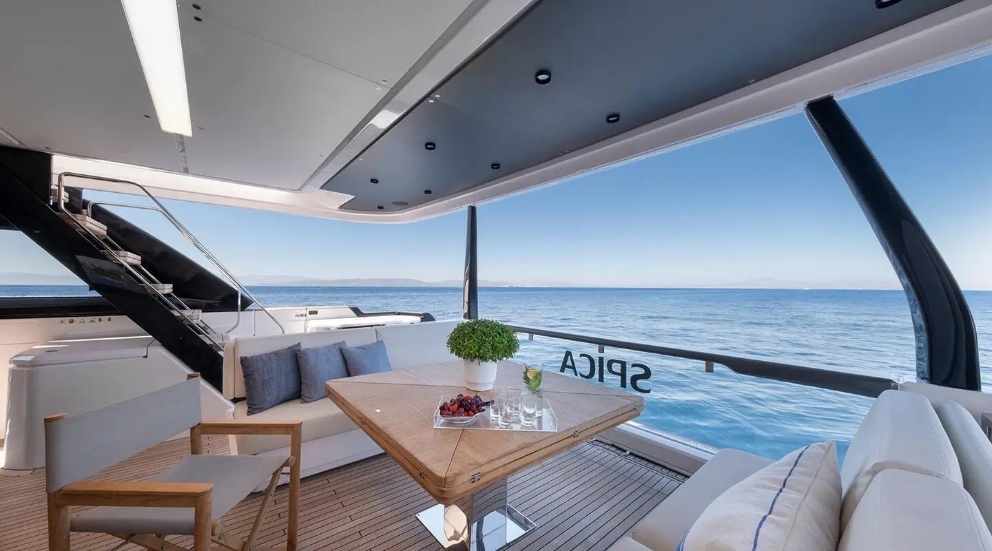 Aft deck on Spica yacht with seating area, table, and ocean view