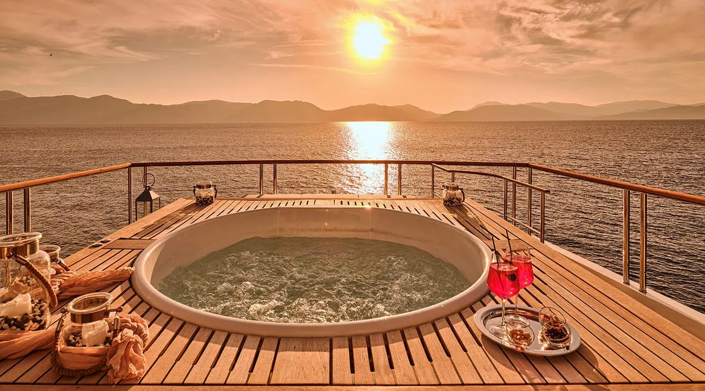 La Pellegrina 1 yacht deck at sunset with round hot tub on railing