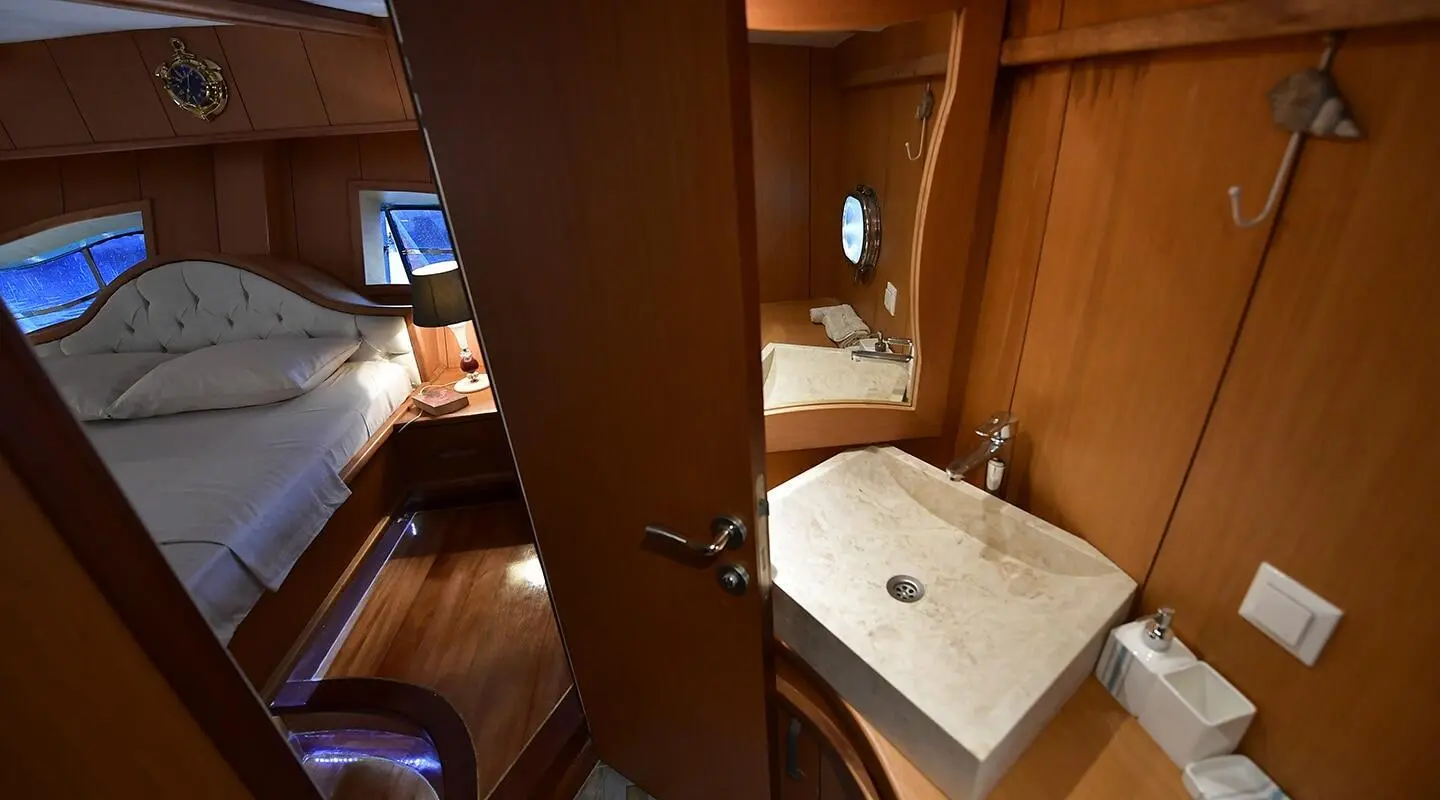Interior of Blu Dream gulet master cabin with wooden panels and bed