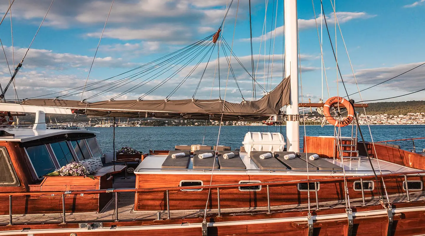 Croatia yacht on calm blue sea with sun loungers and deck, luxury wooden finish