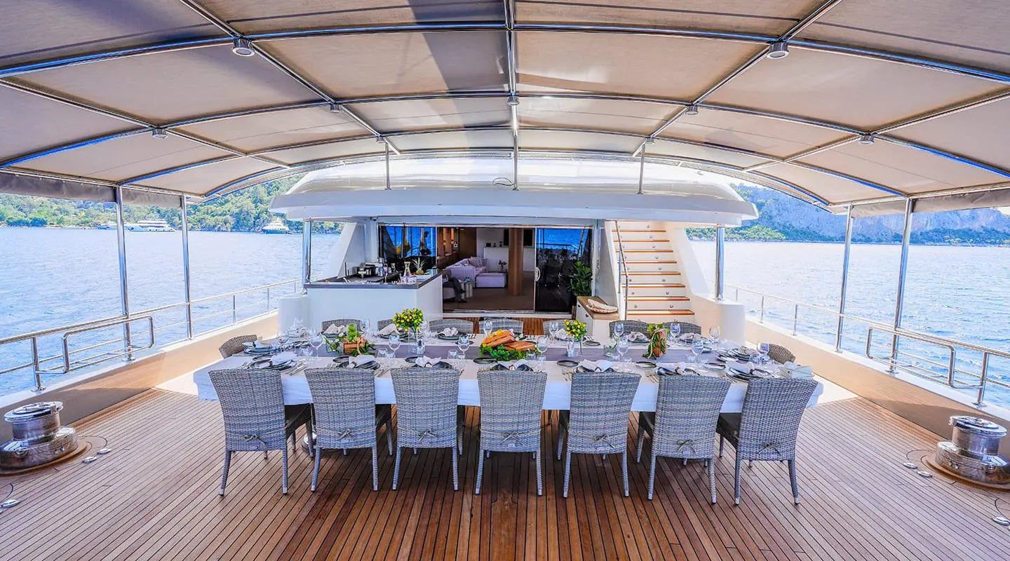 Under-bridge dining deck on King Of The Sea with rows of chairs and a table setup