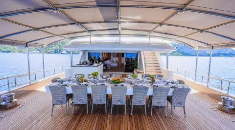 Under-bridge dining deck on King Of The Sea with rows of chairs and a table setup