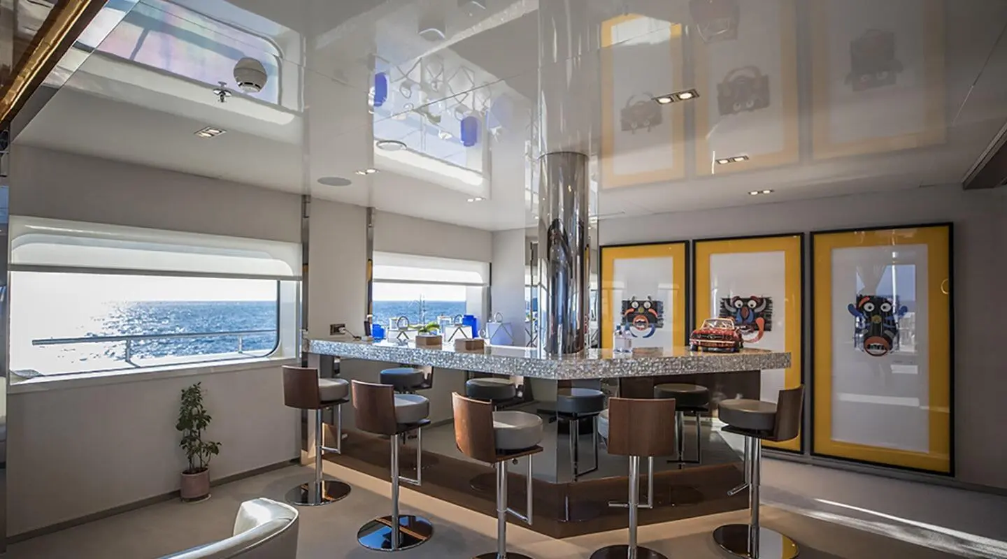 Interior of luxury yacht Marquise with bar, seating, and large windows