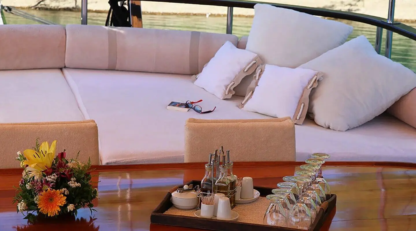 Derin Deniz luxury yacht aft seating with white cushions and barware on polished teak deck