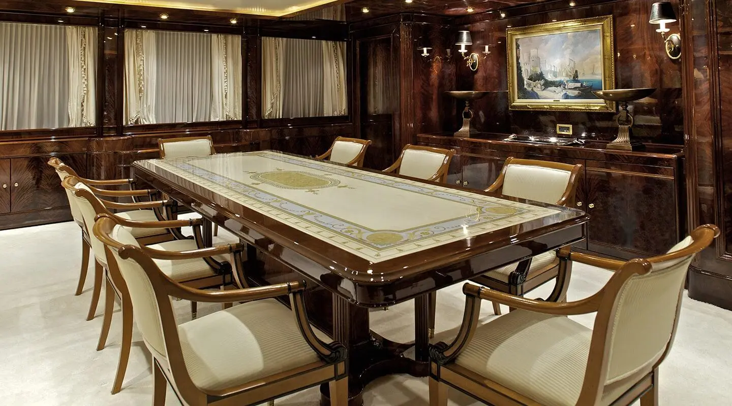 Ornate dining area aboard O'Rion yacht with marble table and elegant chairs