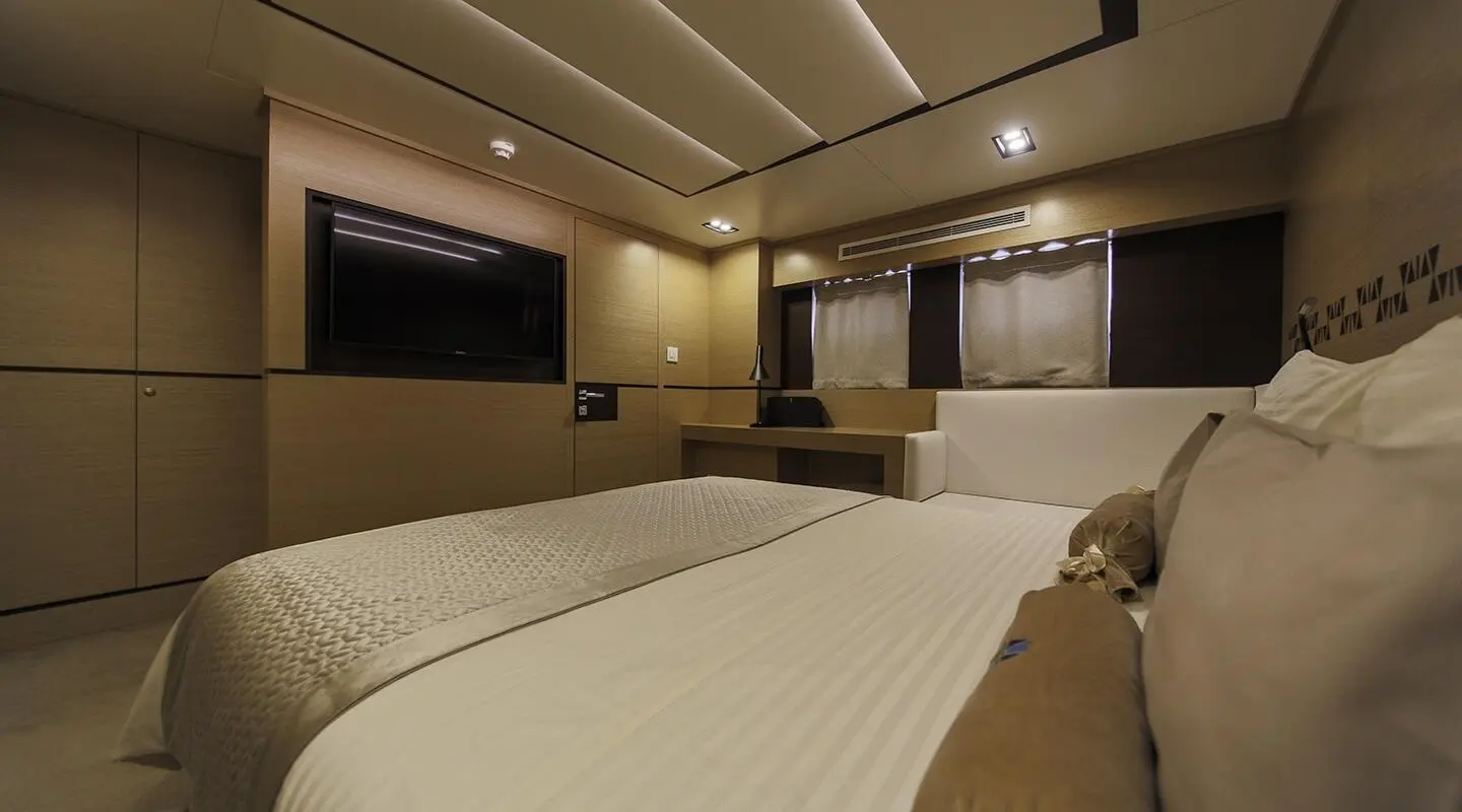 Luxurious Omnia yacht bedroom with two twin beds and soft lighting
