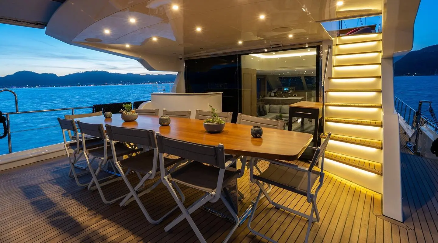 Aft deck of yacht Good Life with seating area and warm lighting