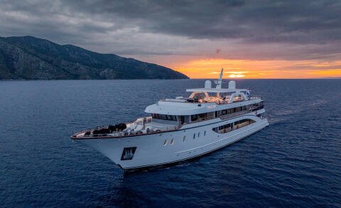 Cristal yacht at sea during sunset with white hull and upper decks visible
