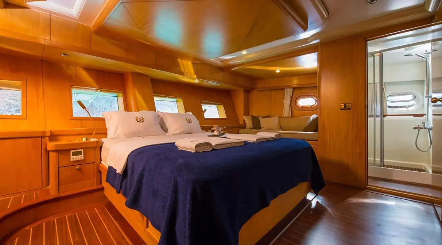 Interior of Mein Schatz yacht cabin with two beds and wooden paneling