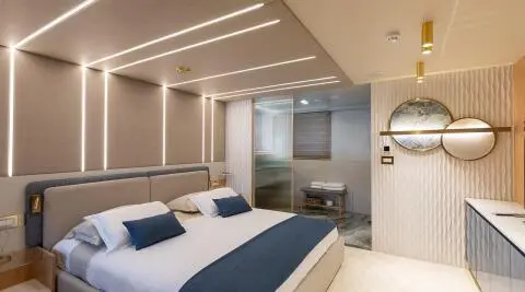Modern bedroom interior with illuminated headboard walls and decorative mirrors