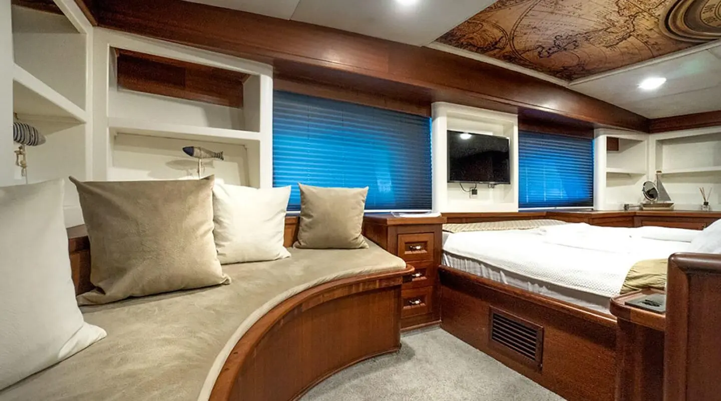 Interior of Virtuoso gulet cabin with curved wood seating and blue cushions