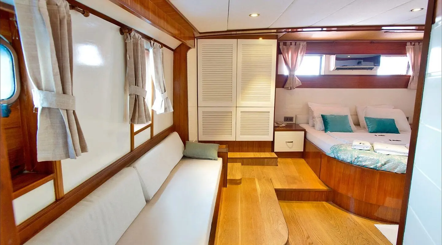 Interior of Maske 2 gulet with wooden floor, seating, and cabin doors