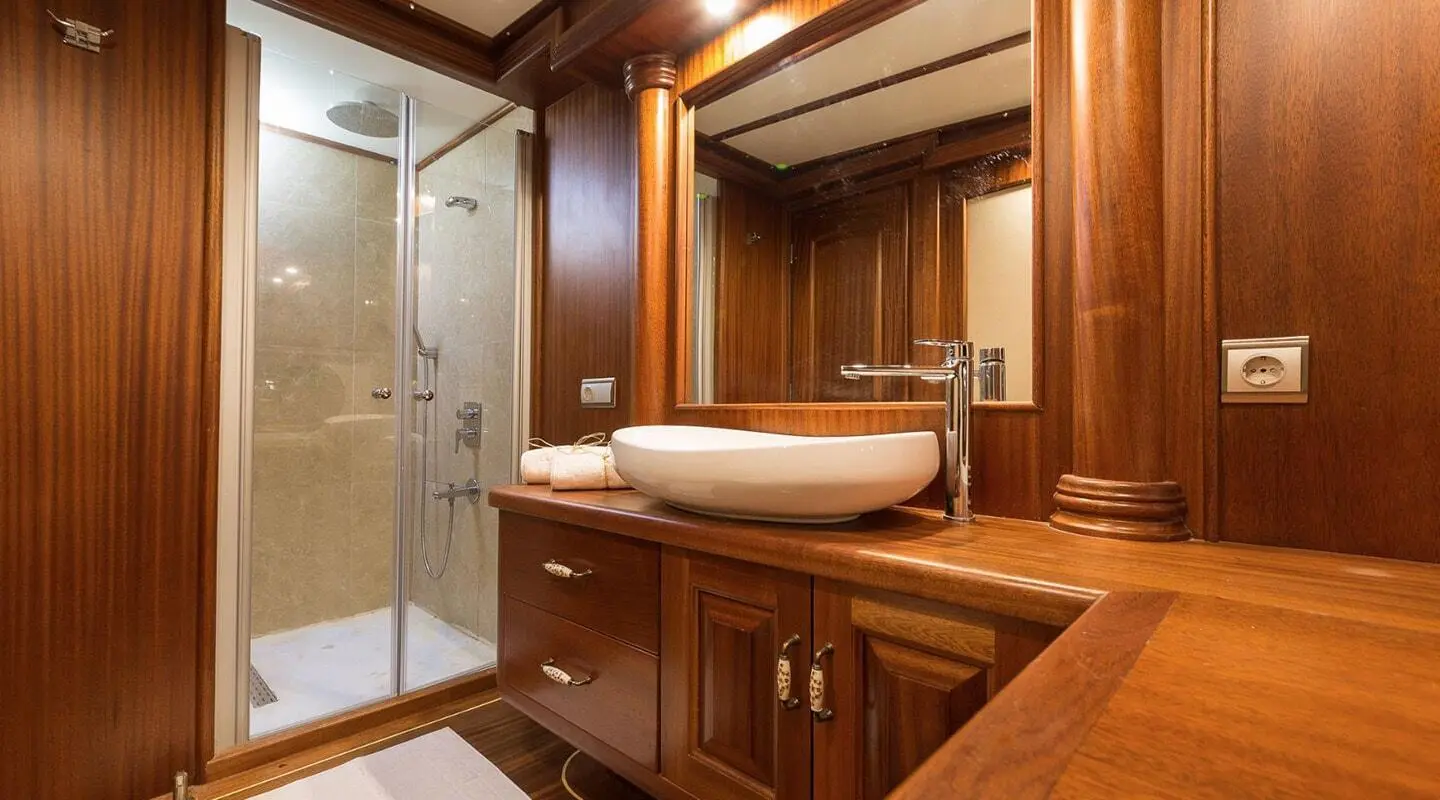 Wood-paneled bathroom with sink and glass shower enclosure