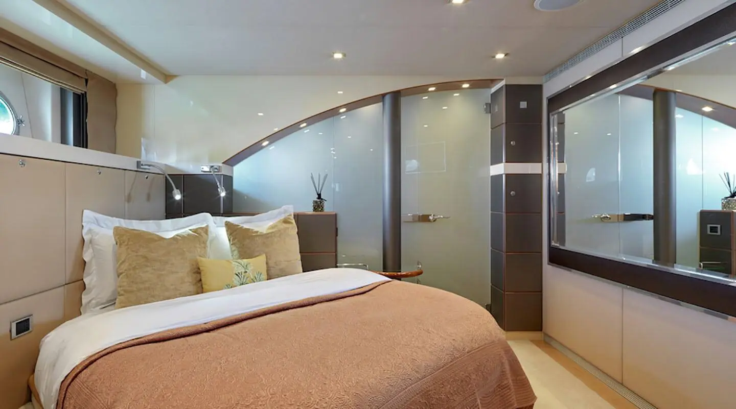 Daloli yacht cabin with bed, beige bedding, and wooden accents visible