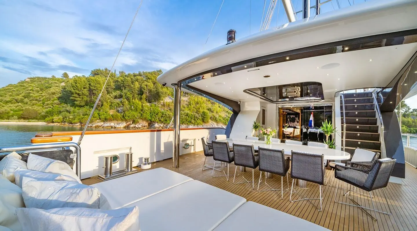 Navilux motor yacht aft deck with seating and sun shade, calm water