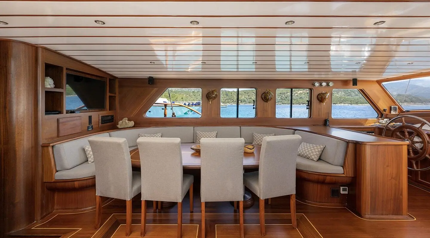 Interior saloon aboard Bedia Sultan gulet, wooden beams and seating area