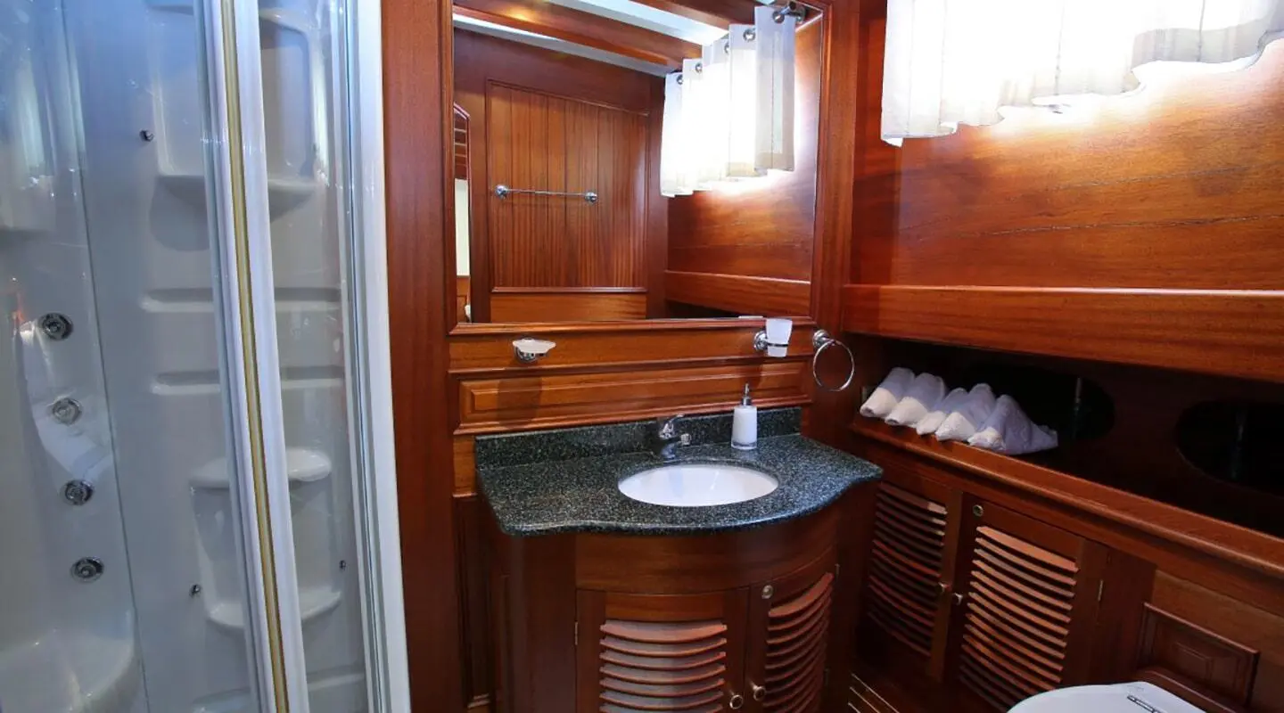 Luxurious yacht Kaya Guneri 4 bathroom area with wooden cabinets and sink