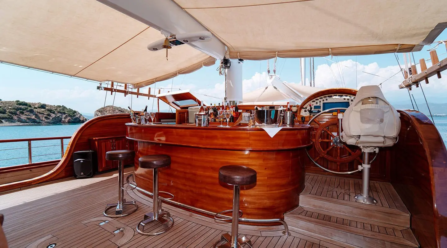 Wooden bar on the Lycian Queen yacht under sunset