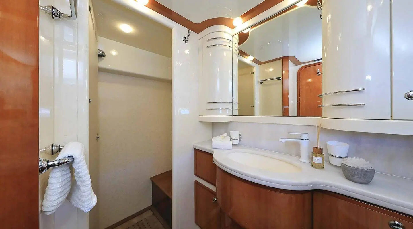 Quo Vadis I master bathroom aboard a yacht with white cabinets and curved sink
