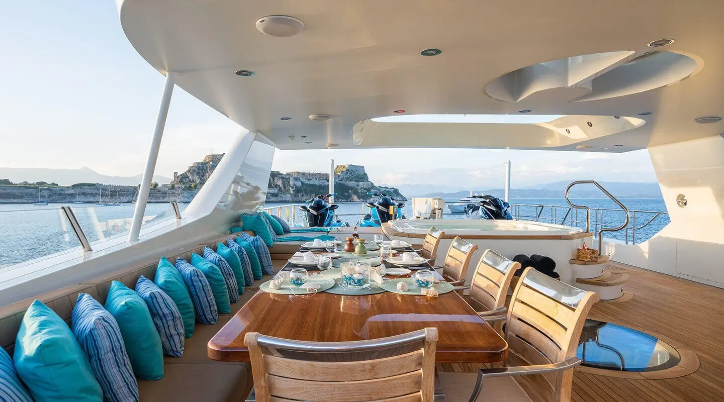 Serenity yacht interior with dining table and decorative settings