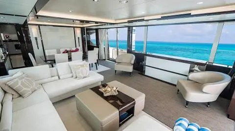 Quantum luxury yacht interior: bright salon with white furnishings and ocean view