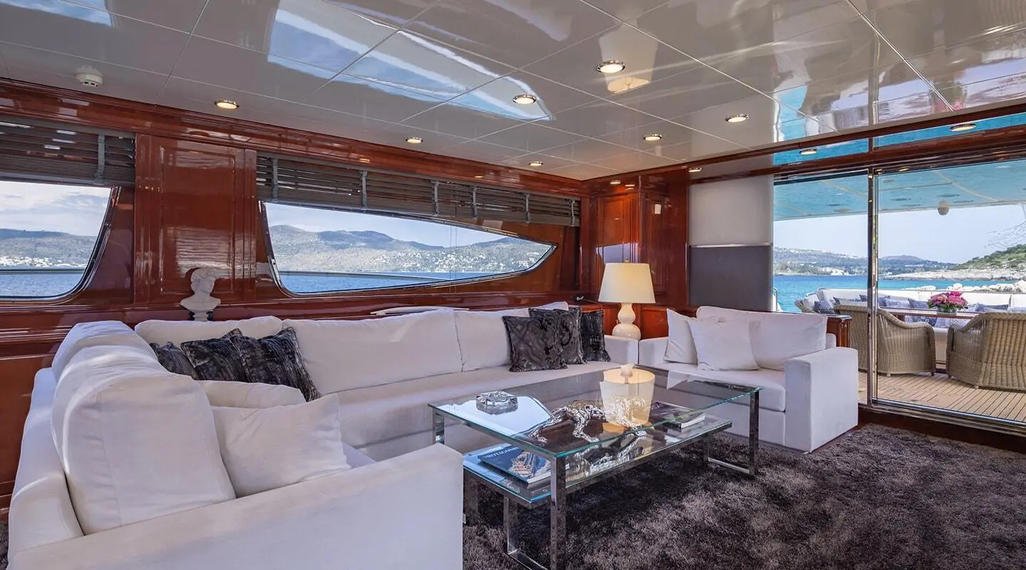 Luxurious yacht salon aboard Divine with white seating and glass windows