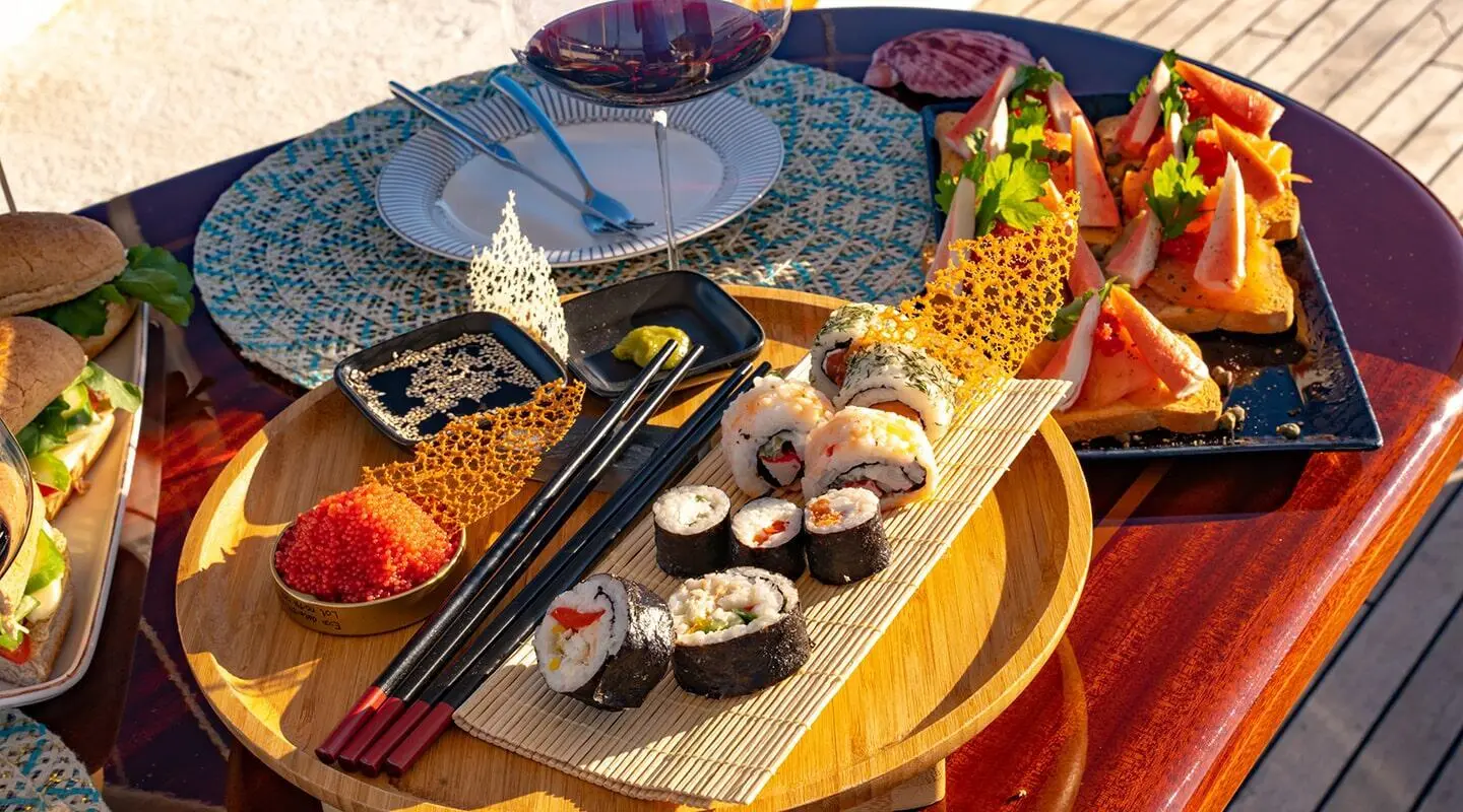 Double Eagle gulet with plated sushi and appetizers on a yacht deck