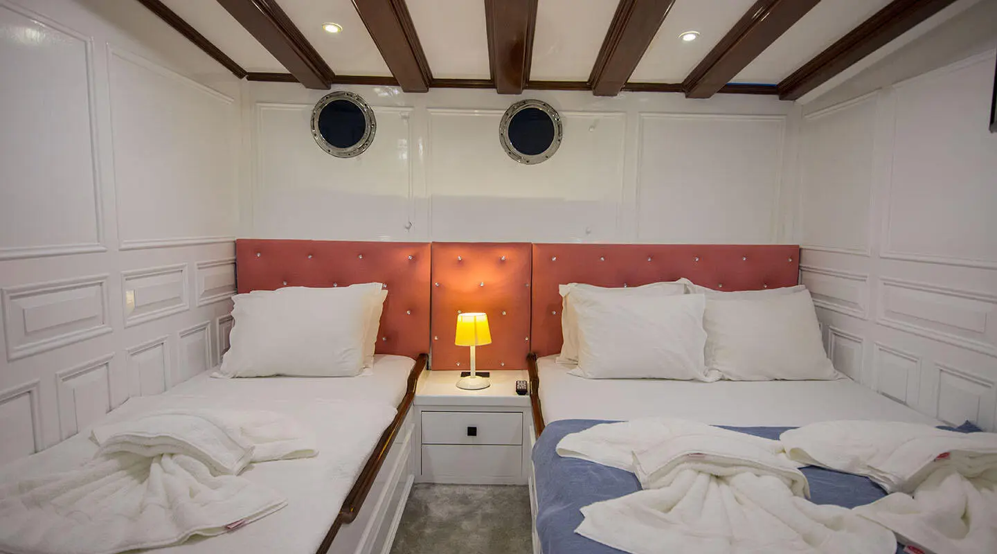 Cozy outdoor seating on a luxury yacht at sunset, with cushions and soft lighting