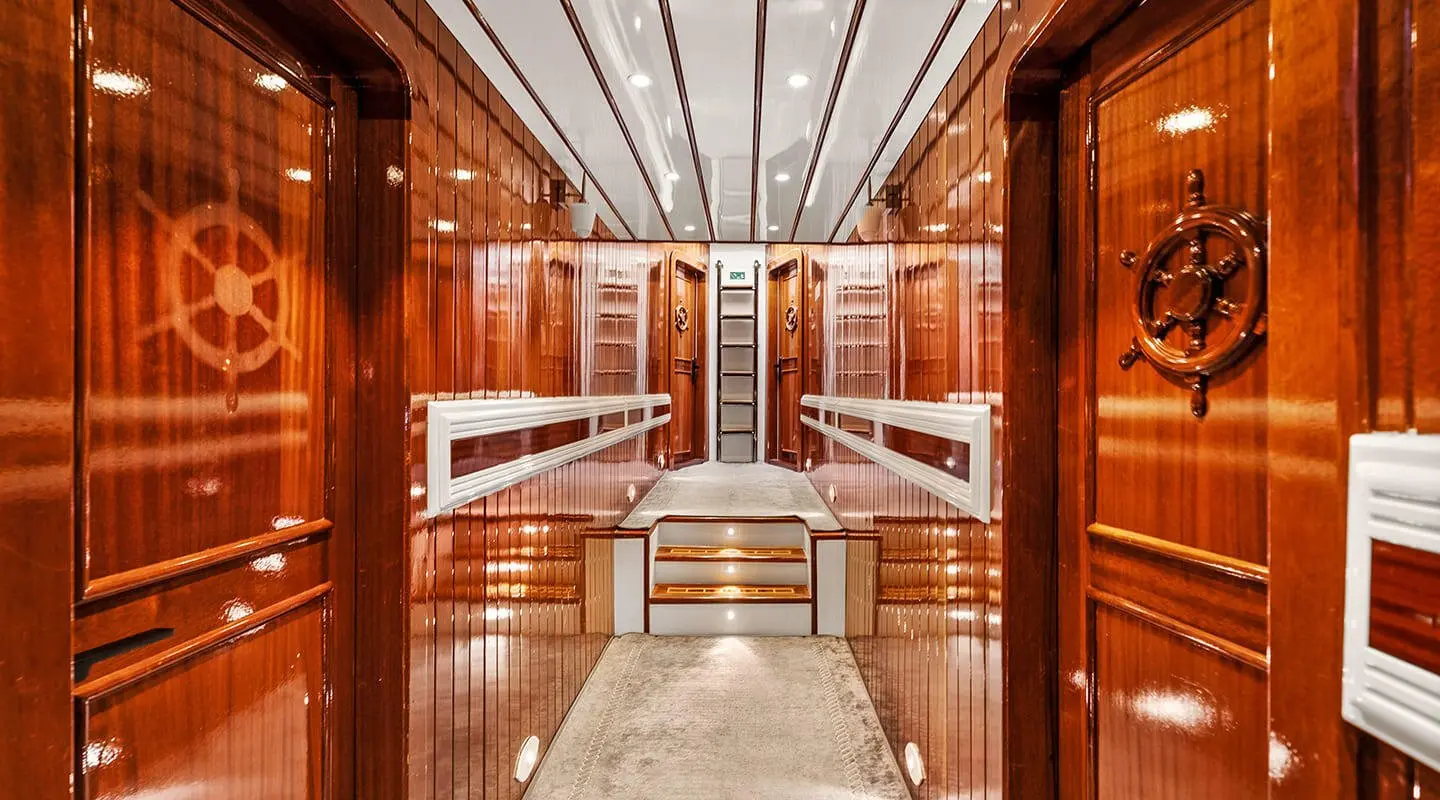 Esma Sultan luxury gulet interior: polished wood, seating, and staircase
